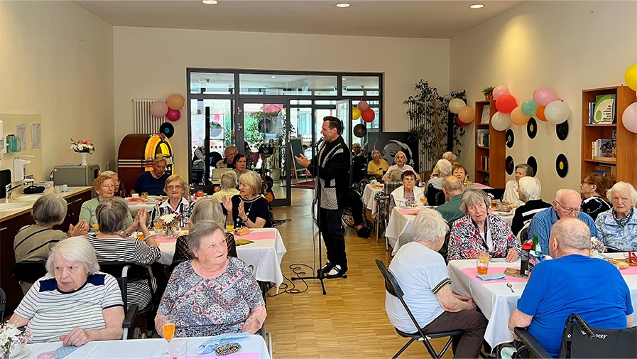 Senior*innen hören Live-Musik der 5oer und 60er Jahre bei der Sommer-Mottoparty in der Seniorenresidenz Park Sanssouci